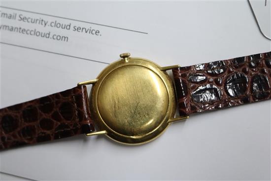 A gentlemans 18ct gold Longines manual wind wrist watch and a yellow metal Realm wrist watch.